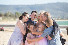 Bride and Groom and children in a big hug at the beach at Safety Beach, Mornington Peninsula, Vic. © Erika's Way Photography